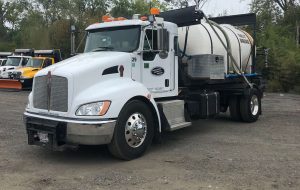 A truck carrying a tank filled with salt brine solution